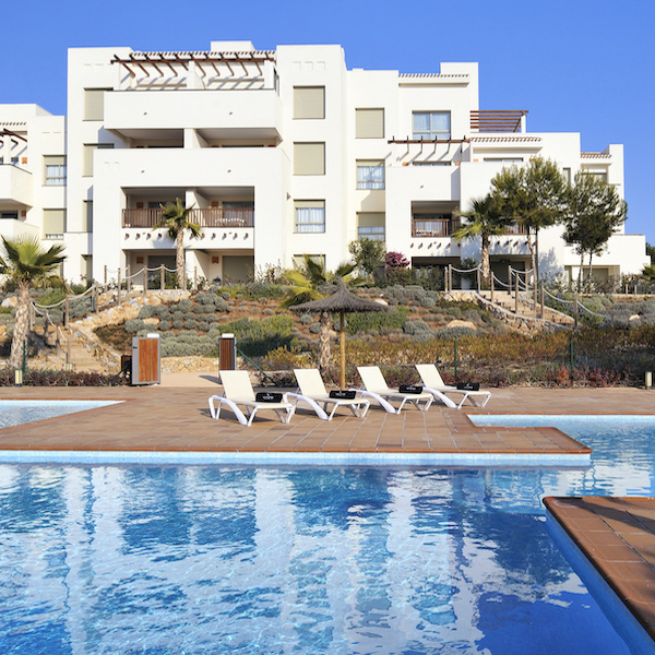 Apartments at Las Colinas Golf Resort with pool in foreground