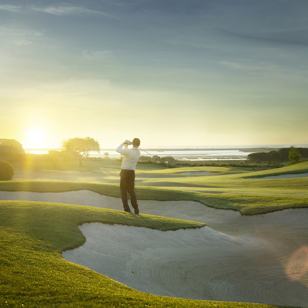 Player shoots from a bunker into the sun on Palmares Golf, Algarve