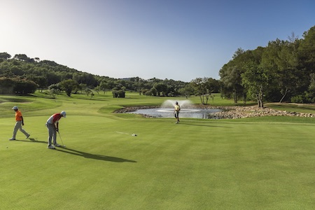 Putting on a green guarded by a pond on Son Muntaner Golf