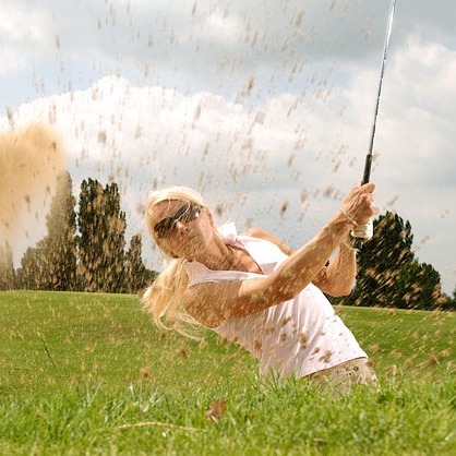 Woman golfer in bunker